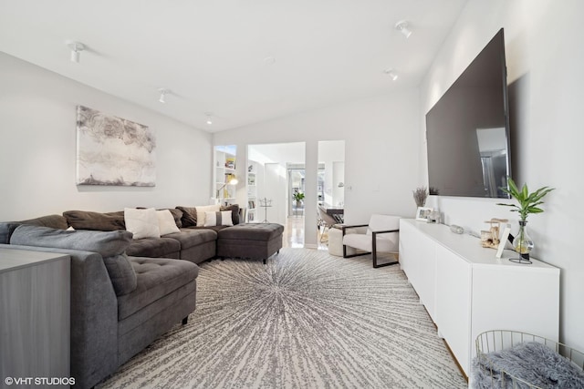 living room with vaulted ceiling and light colored carpet