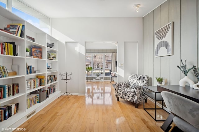 sitting room with lofted ceiling and light wood-type flooring