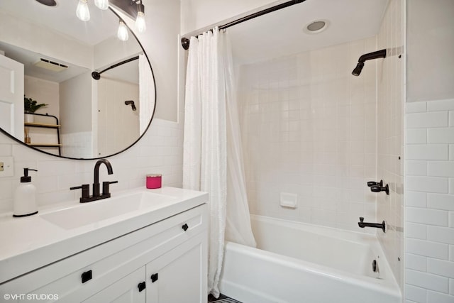 bathroom with tile walls, vanity, and shower / bath combo with shower curtain