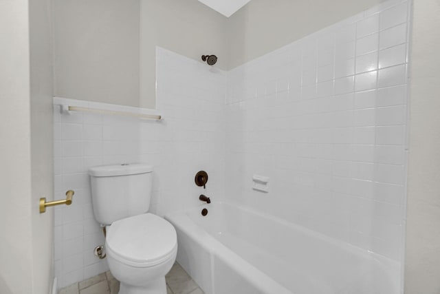 bathroom featuring tile patterned flooring, bathing tub / shower combination, tile walls, and toilet