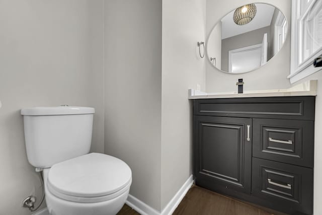 bathroom with vanity, wood-type flooring, and toilet