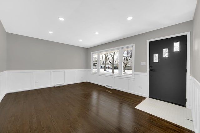 foyer with dark hardwood / wood-style floors