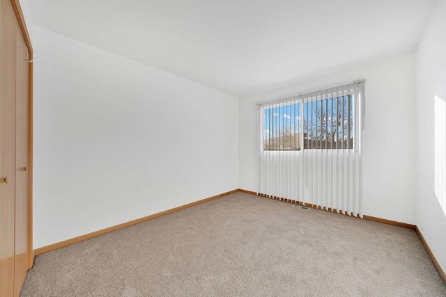 spare room with light carpet