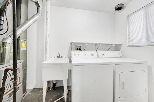 clothes washing area featuring sink and washing machine and clothes dryer