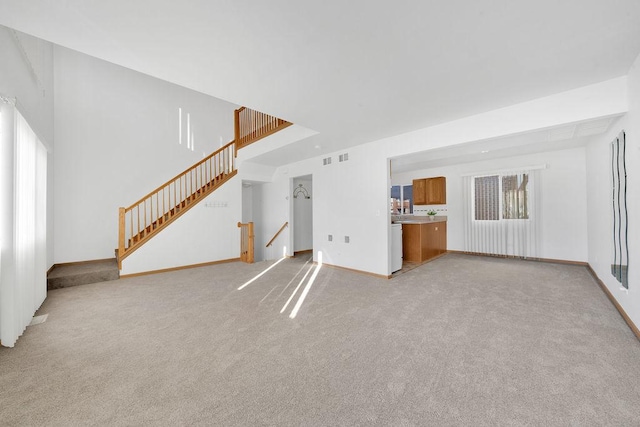 unfurnished living room with light colored carpet