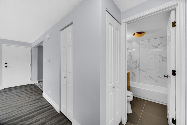 hallway with a textured ceiling