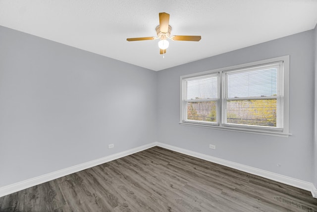 empty room featuring dark hardwood / wood-style floors and ceiling fan