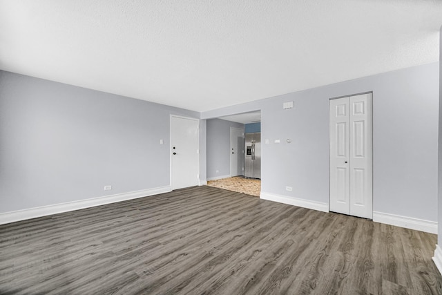 empty room featuring dark hardwood / wood-style flooring