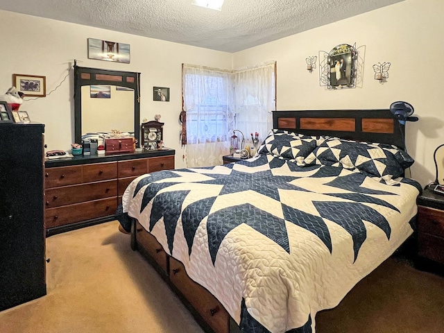 bedroom featuring light carpet and a textured ceiling