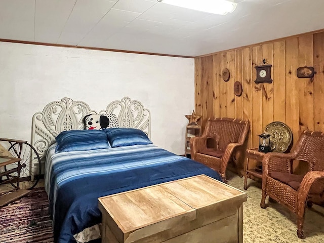 carpeted bedroom featuring wooden walls