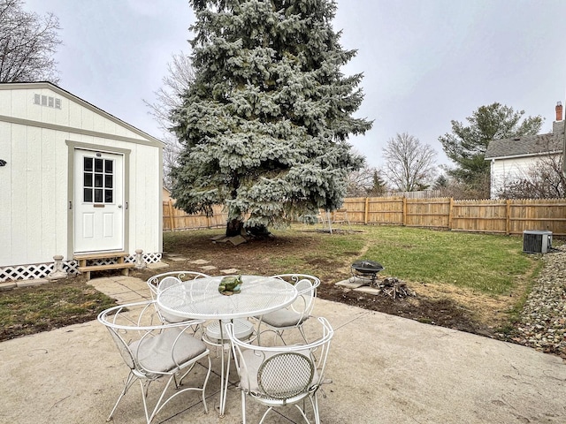 view of patio / terrace with a storage unit and an outdoor fire pit