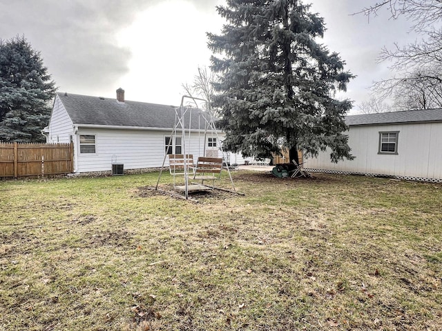 back of house with a lawn