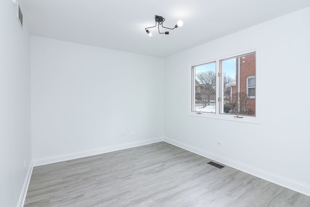 spare room with light hardwood / wood-style flooring