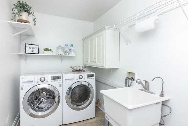 washroom featuring sink, cabinets, and washer and clothes dryer