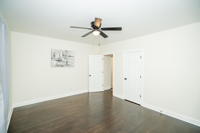 empty room with dark wood-type flooring and ceiling fan