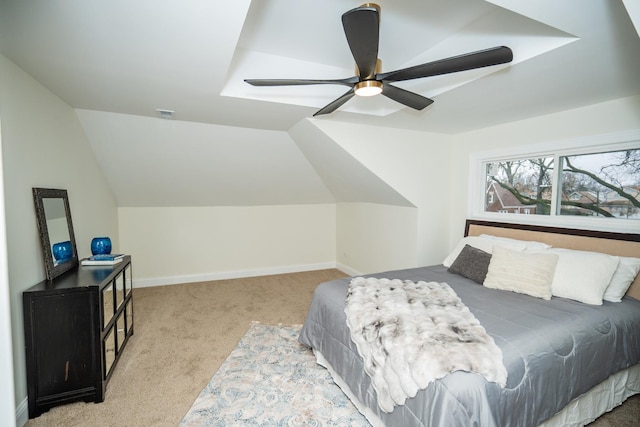 bedroom featuring light colored carpet, vaulted ceiling, and ceiling fan