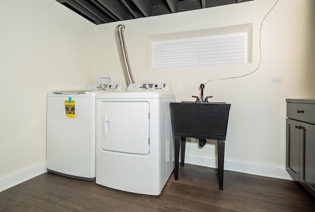 clothes washing area featuring dark hardwood / wood-style floors and washing machine and clothes dryer