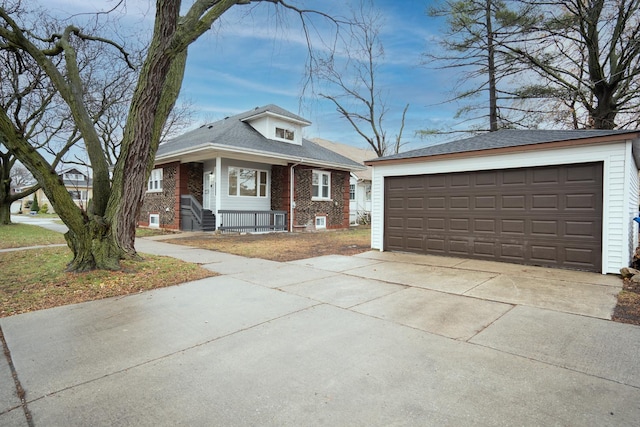 view of front of home featuring a garage and an outbuilding