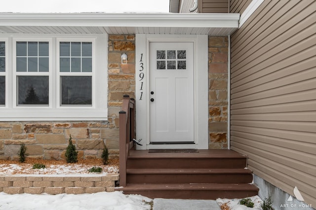 view of snow covered property entrance