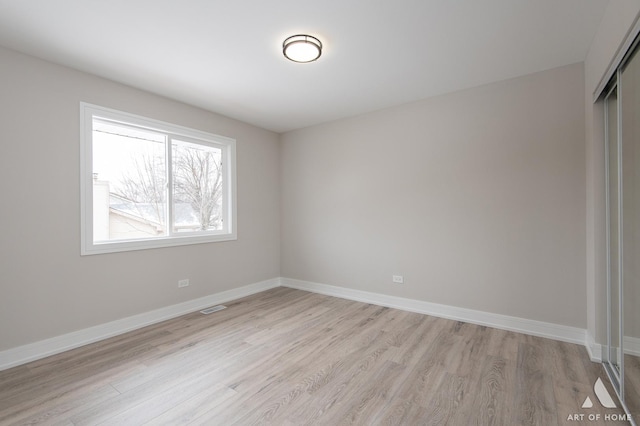 spare room featuring light hardwood / wood-style floors