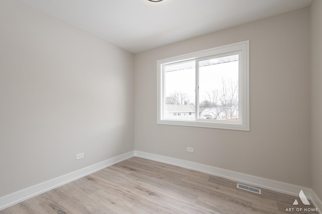 spare room featuring light hardwood / wood-style flooring