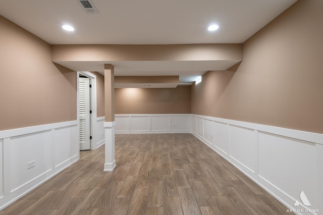 basement with light hardwood / wood-style floors