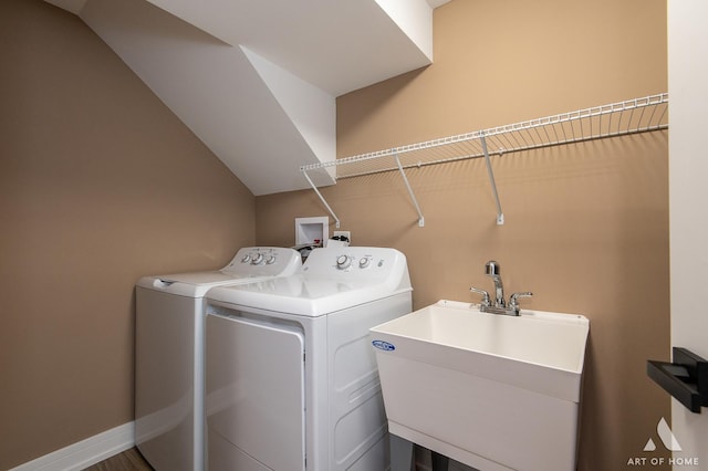 clothes washing area with sink and separate washer and dryer