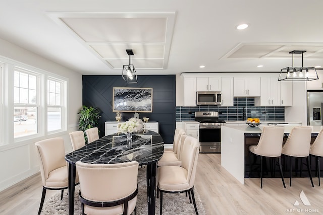 dining room featuring sink and light hardwood / wood-style flooring