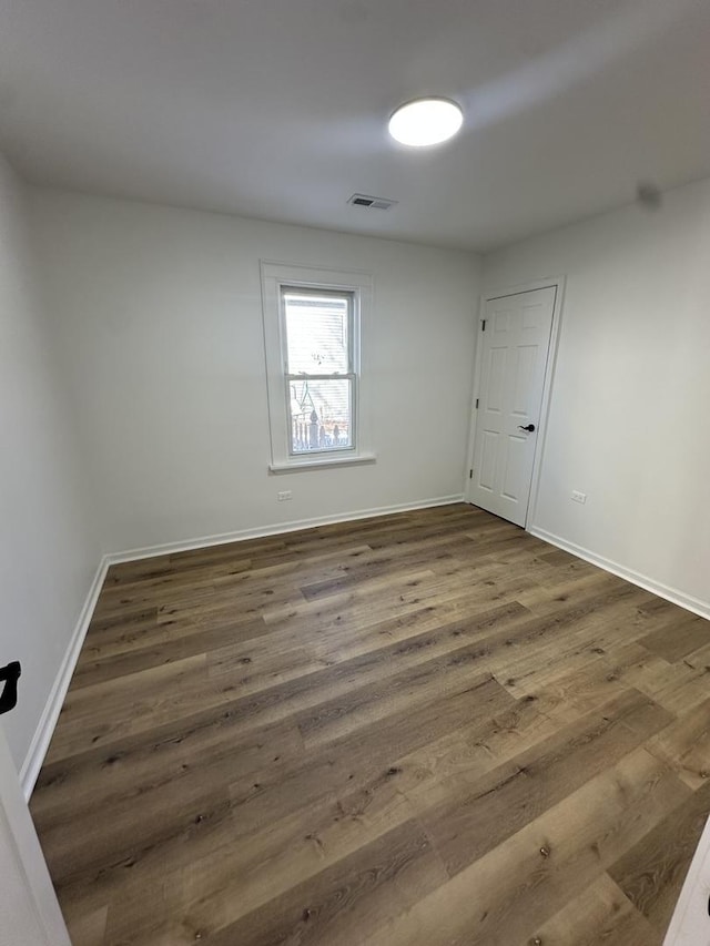 empty room featuring dark wood-type flooring