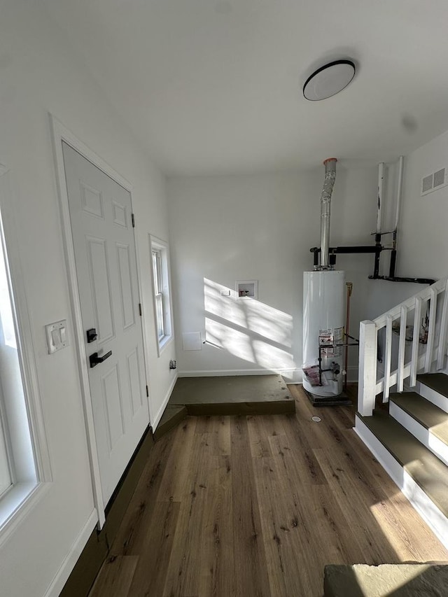 entryway featuring water heater and dark wood-type flooring