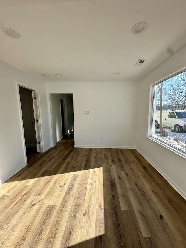 empty room with hardwood / wood-style flooring