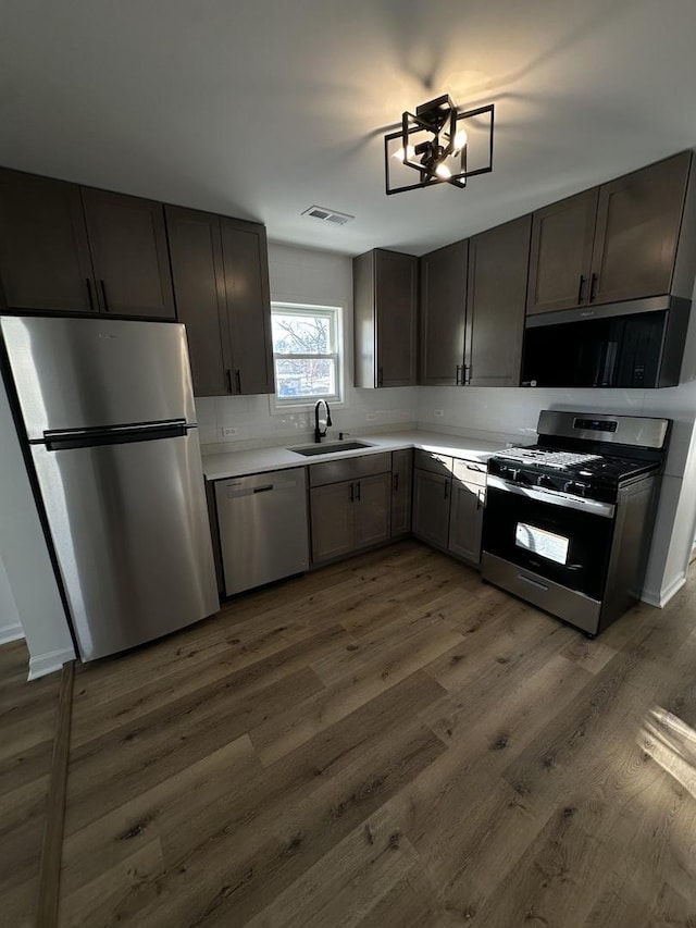 kitchen with sink, stainless steel appliances, and dark hardwood / wood-style floors