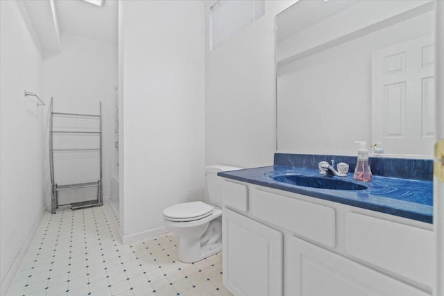 bathroom with walk in shower, vanity, and toilet