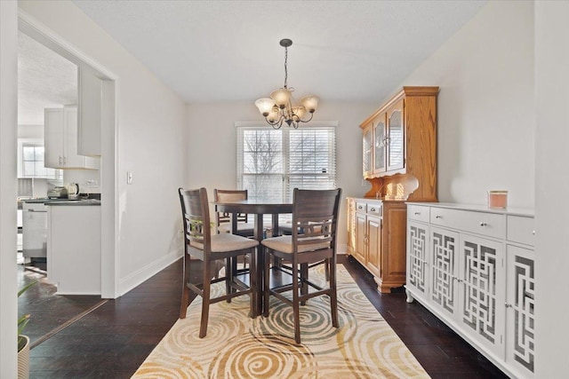 dining room featuring dark hardwood / wood-style flooring and an inviting chandelier