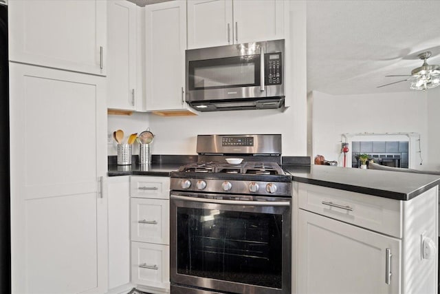 kitchen with white cabinetry, a textured ceiling, kitchen peninsula, ceiling fan, and stainless steel appliances