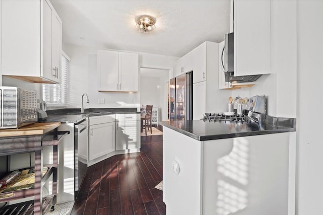 kitchen with appliances with stainless steel finishes, sink, and white cabinets