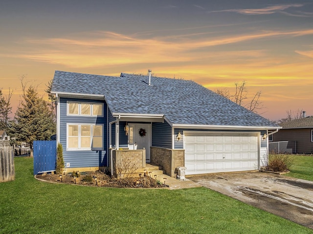 view of front of property featuring a yard and a garage