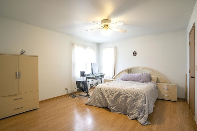 bedroom with light hardwood / wood-style floors and ceiling fan