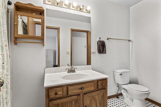 bathroom featuring vanity and toilet