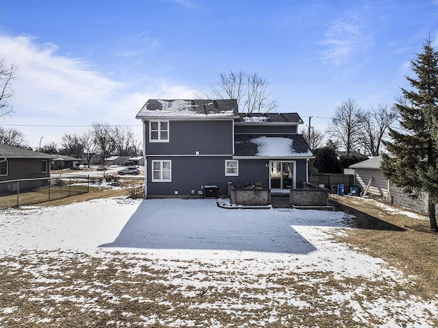 view of snow covered back of property