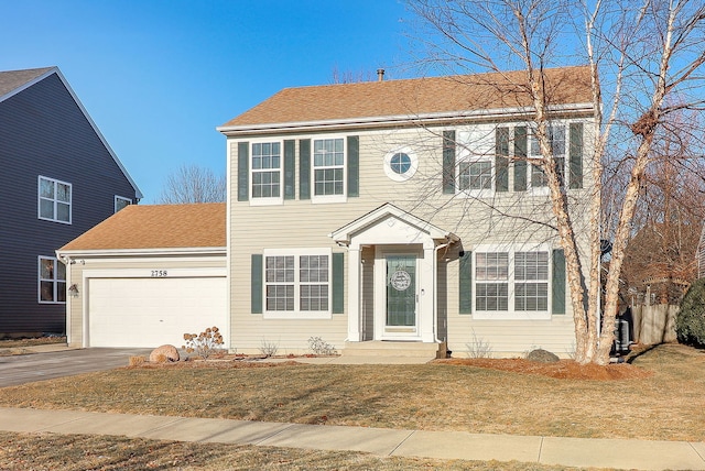 colonial home featuring a garage and a front yard