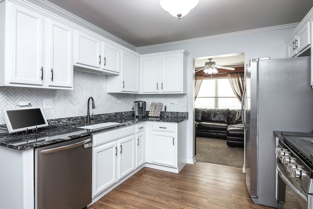 kitchen featuring appliances with stainless steel finishes, sink, and white cabinets