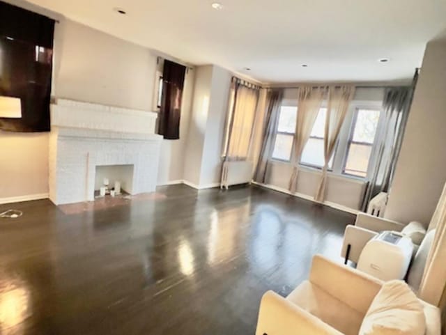 living room featuring dark hardwood / wood-style floors and a fireplace