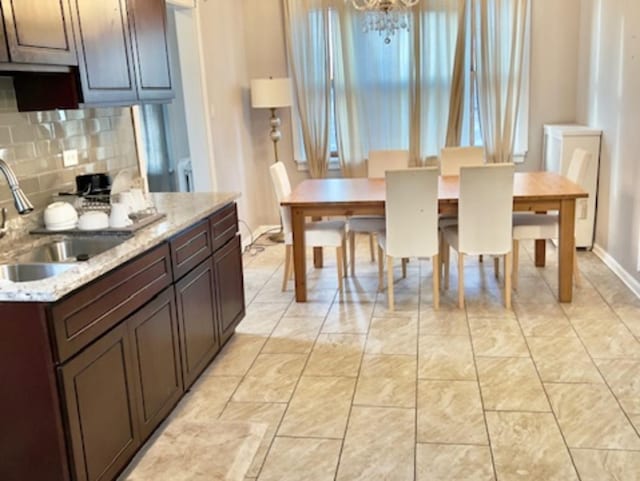 dining area with sink and an inviting chandelier