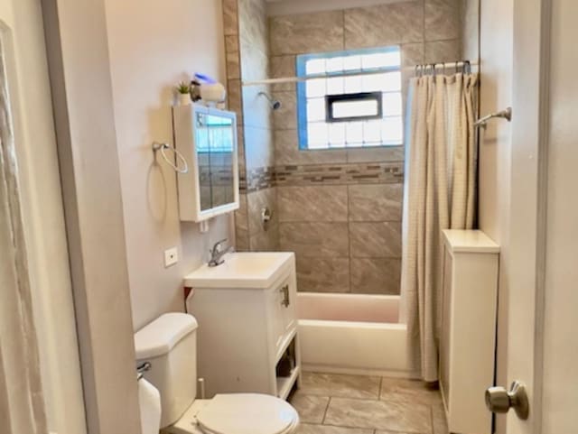 full bathroom with toilet, vanity, and shower / tub combo with curtain