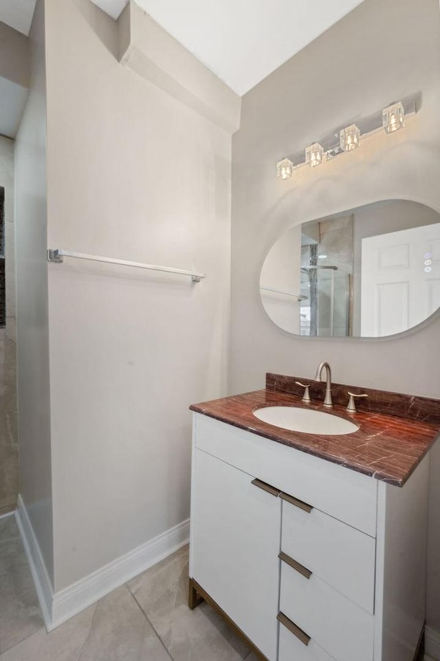 bathroom with tile patterned flooring, an enclosed shower, and vanity