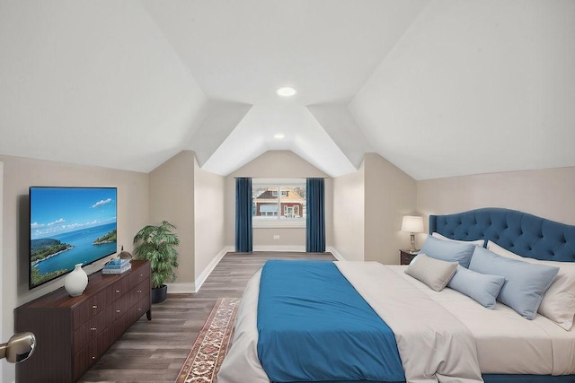 bedroom featuring dark hardwood / wood-style flooring and lofted ceiling