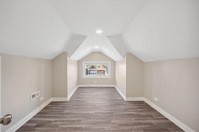 additional living space featuring hardwood / wood-style floors and lofted ceiling