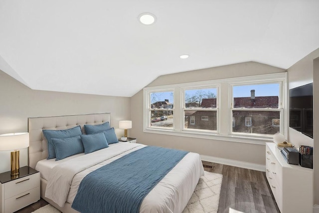 bedroom with light hardwood / wood-style floors and lofted ceiling