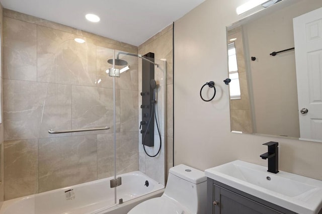 full bathroom with vanity, toilet, and enclosed tub / shower combo